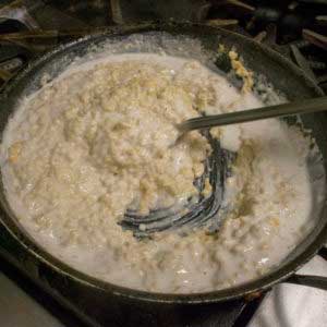 Simmer over low, stirring continually until it thickens, then add the last cup of milk.