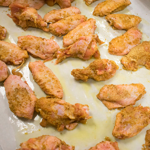 chicken wings in oil and rub