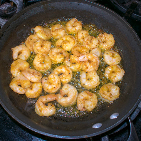 aip rub on shrimp being grilled in skillet