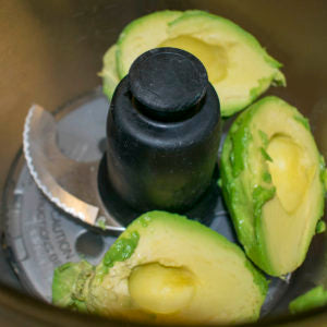 Add avocados to food processor