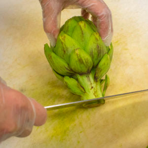 Trim the discolored end of the artichoke