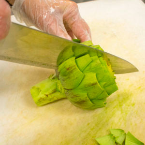 Cut the artichoke in half through the stem