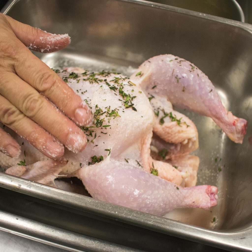 Rub seasoning over outside of chicken