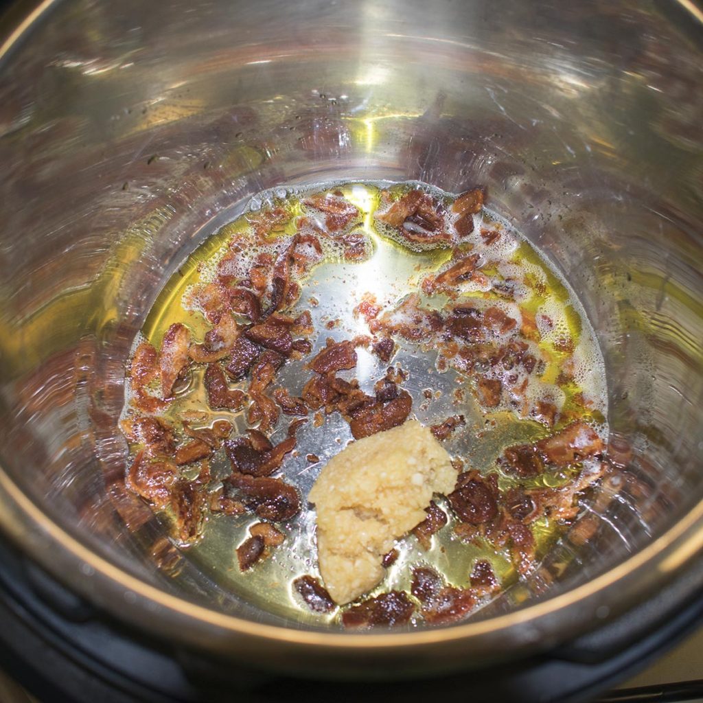 Sauté olive oil and bacon in an instant pot
