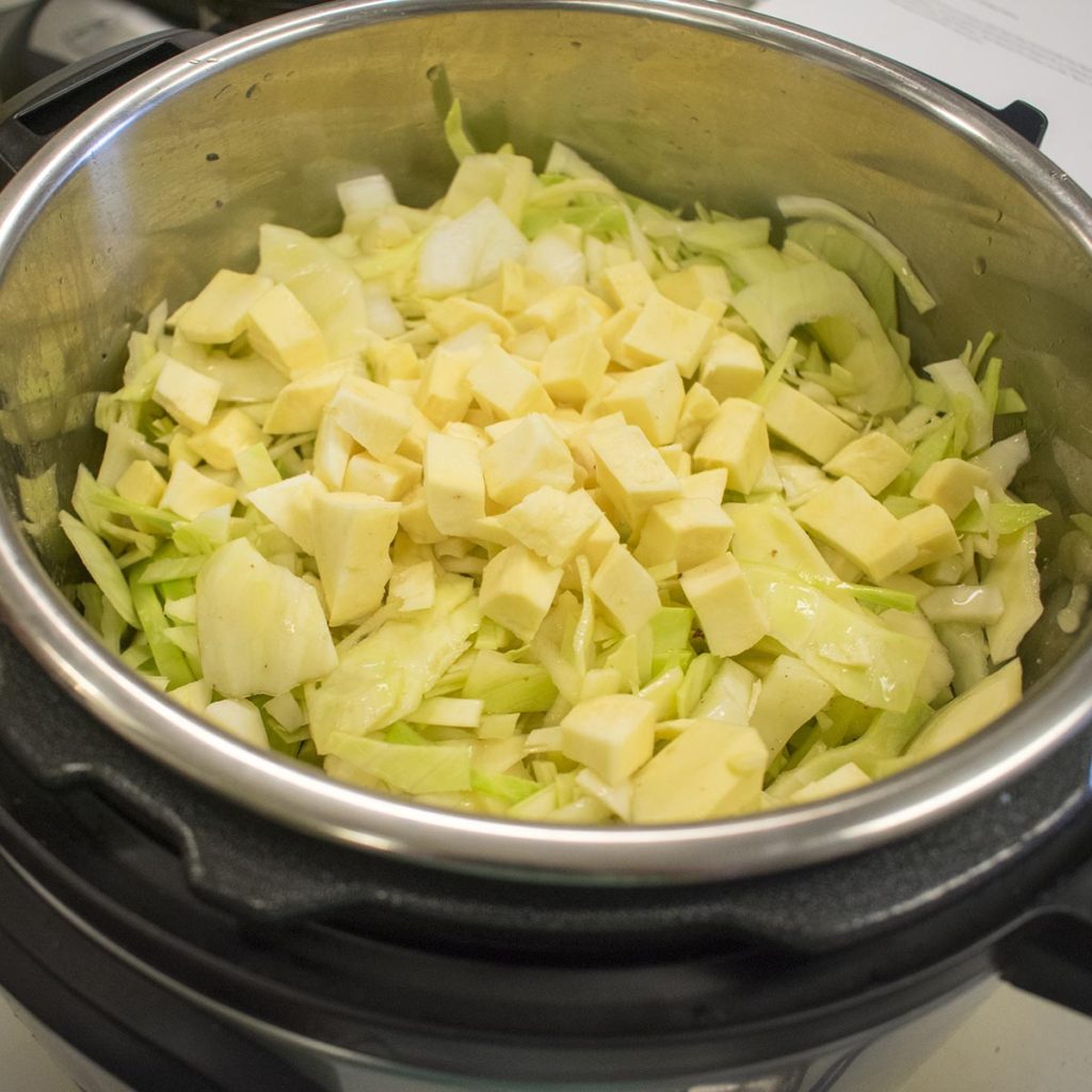 Add the bone broth and all of the other ingredients, except spinach and parsley