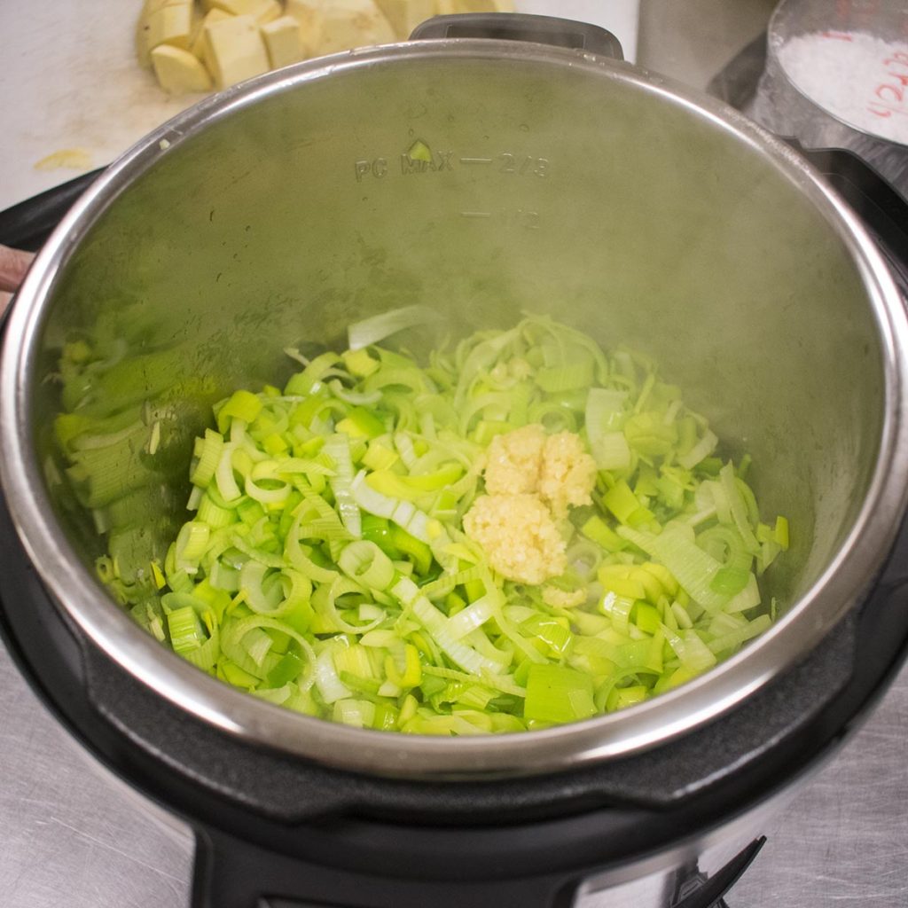 add olive oil and then add garlic and leek and sauté for 5 minutes until soft and sweet