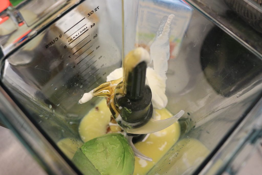 place avocado, coconut cream, orange juice into blender