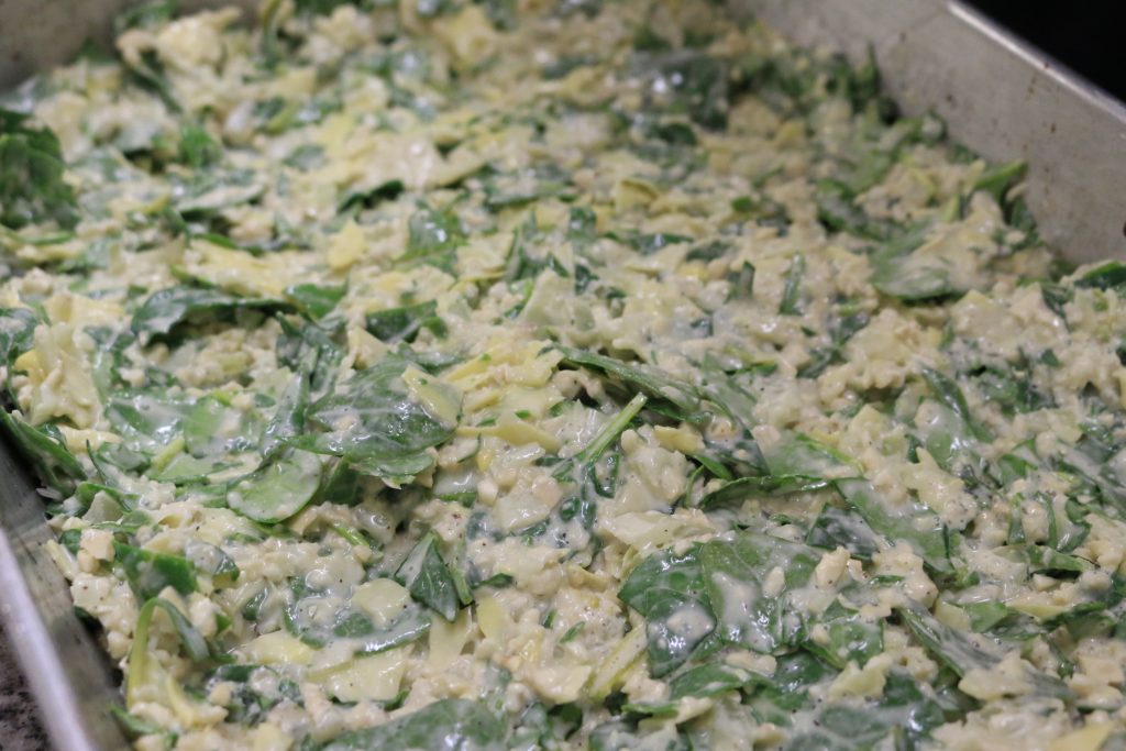 pour aip paleo spinach artichoke dip ingredients into baking dish