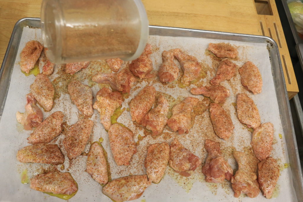 spread wings out on a parchment lined sheet tray