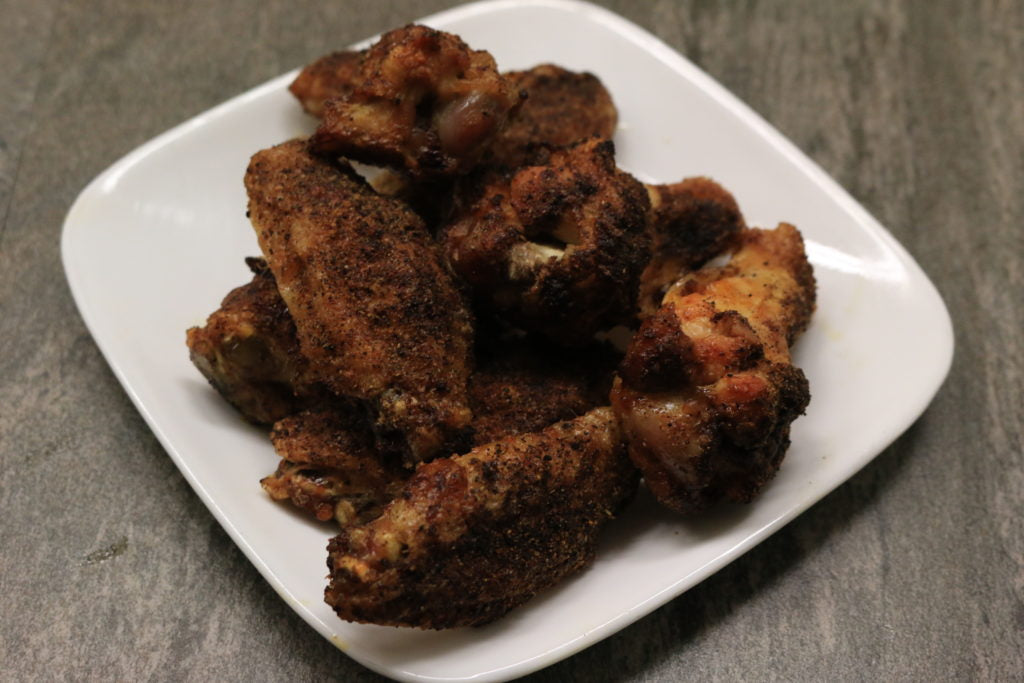 Bake in a 400 degree oven for 15 minutes. Remove and sprinkle on another layer of dry rub. Return them to the oven for another 15-20 minutes until golden and crisp.