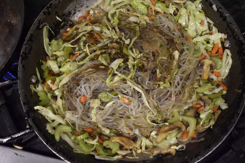 Add the sauce and noodles to the pan with the vegetables and bring to a simmer.