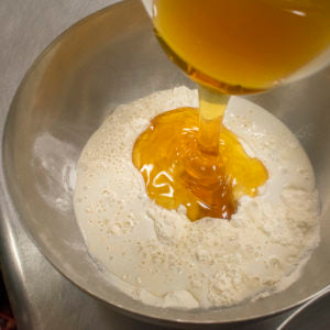 Add honey to the mixing bowl