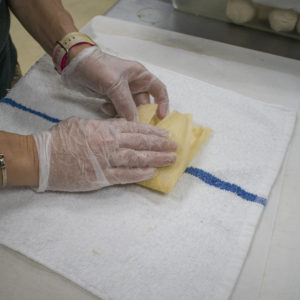 roll the husk from left to right, leaving the top open