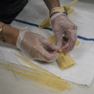 Pull a thin strip off one of the husks to make a string