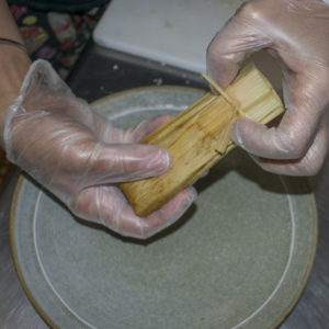 Once steamed, pull a tamale out of the instant pot
