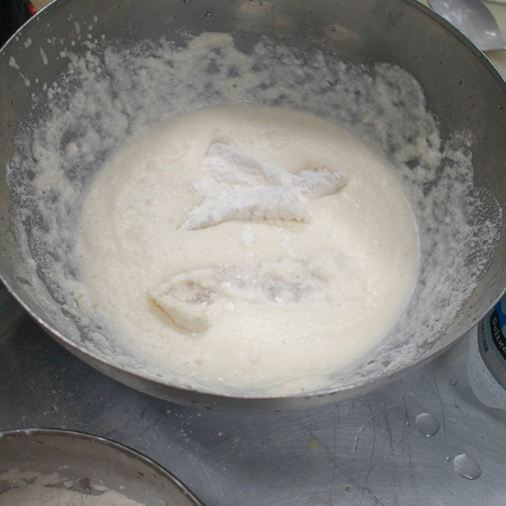 Roll a few pieces of fish at a time into the bowl of dusting flours