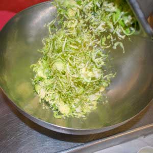Combine shredded brussels sprouts, cabbage and carrots in a bowl
