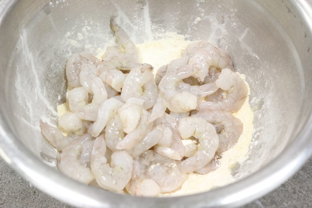 Dredge shrimp lightly in flour