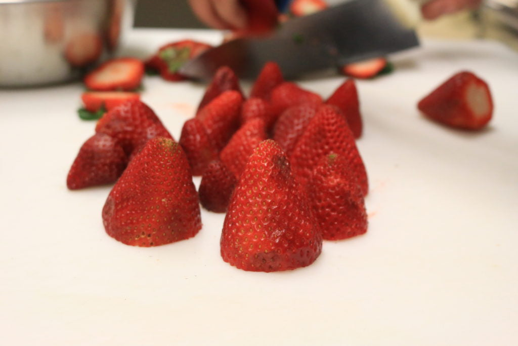 Cut the strawberries in half