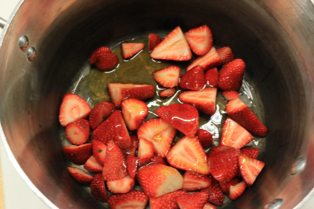 In a sauce pan over medium-high heat, stir in berries and lemon juice