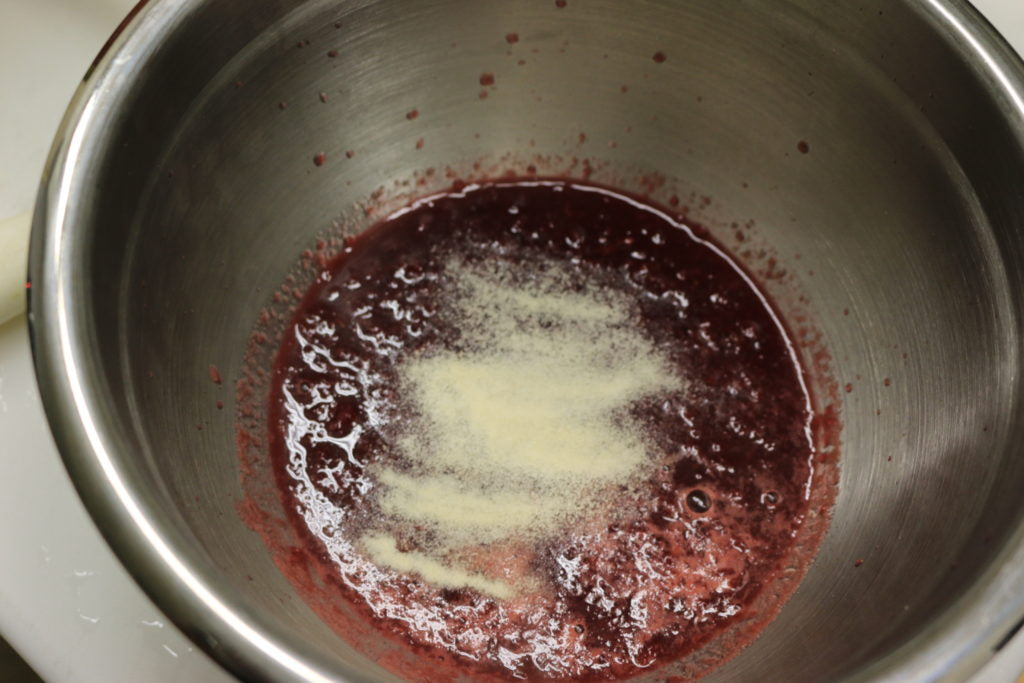 In a sauce pan over medium-high heat, stir in berries and lemon juice.